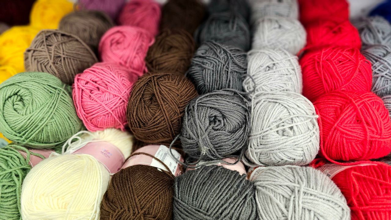 An array of colorful yarn balls perfect for knitting, crochet, and crafting enthusiasts.